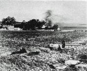 Operation Barbarossa: A Soviet machine gunner who was killed in a field near the outskirts of the village. June 1941 In the background to the burning house are Wehrmacht soldiers. Eastern front. from pujnabi village school enjoing in the classroo