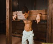 Back flogging of the handsome prisoner in the wooden stocks. A pic from RusCapturedBoys.com video Georgiy in Pain - Part II. from gerli sex wwxx com video mobelal ram ch