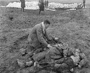 A Soviet man finds the bodies of his wife and children, who were killed by a Nazi death squad. His family were among approximately 7000 murdered civilians, mostly of Jews, whose bodies were found by Soviet troops after they retook the area, Crimea, 1942 [ from crimea bpy