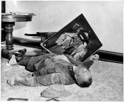 Fearing capture by US troops after Nazi defeat, Major Walter Doenicke of the Volkssturm lies dead next to a torn picture of Hitler after ingesting cyanide from bhabi after bathing video capture by hubby