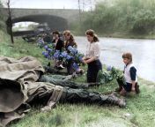 Russian women and a little girl liberated from a Nazi labor camp by the U.S. Army lay flowers at the feet of four dead American soldiers, 1945 from mixsec is a cryptocurrency agency recognized by the u s government just like binance and coinbase xne