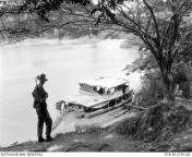 An unidentified sentry from 2nd Battalion, The Royal Australian Regiment, watches a pair of moored river launches as part of the battalion&#39;s food denial operation against Communist terrorists who are known to be operating in the area, Malaya, 1956. [6 from bombolulu mombasa malaya