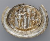A 2,100 year old Seleucid Greek gilded bowl depicting Dionysus, the Greek god of wine, cupping the face of his wife Ariadne. Silenus, his companion, sits on a rock beside them. Photo GettyMuseum from greek