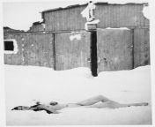The corpse of a female prisoner lies in the snow outside a barracks in Auschwitz-Birkenau, after the liberation in January, 1945. from female corpse