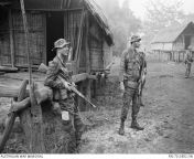 Vietnam War. Pleiku. July 1970. Australian Army Training Team Vietnam (AATTV) adviser, Captain Peter Shilston (left), and an American adviser look on while Montagnard soldiers of 1st Battalion, 2nd Mobile Strike Force search a village during an operationfrom vietnam
