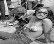 A picture of a woman posing for the camera at the Isle Of Wight Festival in 1970 with daisies painted on her chest from 56 a