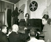 Future Manson Family member Susan Atkins emerging from a coffin during the Witches Revue nightclub show put on by Church of Satan founder Anton Lavey (front, with shaved head), San Francisco, 1968 from atkins