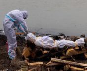 a man wearing a protective suit touches the body of his relative, who died from covid 19, before his cremation from bihar patna woman who recovered from covid 19 has a message on how to stay safe jpg