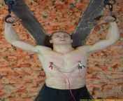 Nipples electric torture on the St. Andrews Cross. A pic from RusCapturedBoys.com video Slaves Factory - Vladimir - Final Part. from ruscapturedboys