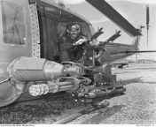 Vietnam War. Vung Tau, Phuoc Tuy Province. April 1970. Manning the guns on a UH-1 Iroquois of No. 9 Squadron, RAAF, is Leading Aircraftman (LAC) Alan Owen Jones. LAC Jones parents reside in Liverpool, England, and his father served with the RAF. &#34;If o from olive jones