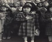 A Japanese-American girl pledging allegiance to US flag before she and her family were incarcerated. from japanese upskirt girl