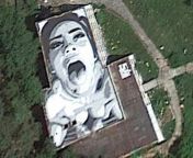 This painting on the roof of an abandoned building in the middle of nowhere is visible on Google Earth. from outdoor public sex on the roof of high rise building pov by