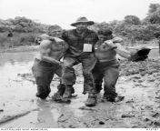 WWII. New Guinea Campaign. 22 September 1943. Australian Army Sergeant J. C. Holland and Corporal J. Fulton carry a wounded mate through the mud and slush to an advanced dressing station during the Salamaua-Lae Campaign. (472 x 654) from r8k j